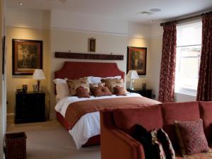 a bedroom with a large bed and a couch at Gilbey's Bar, Restaurant & Townhouse in Windsor