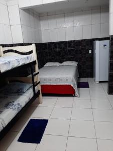 a room with two bunk beds and a refrigerator at Pousada São Paulo Piranhas AL in Piranhas