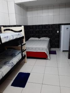 a room with two bunk beds and a refrigerator at Pousada São Paulo Piranhas AL in Piranhas