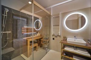 a bathroom with a shower and a sink and a mirror at Five Seasons Szklarska Poręba in Szklarska Poręba