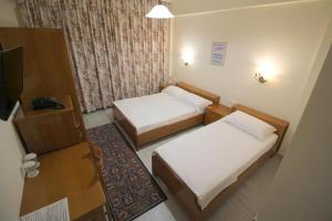 Postel nebo postele na pokoji v ubytování Hotel Ari