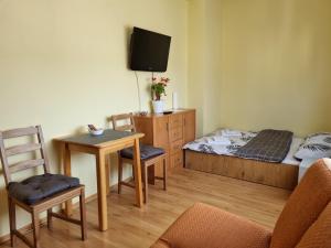 Camera piccola con letto, tavolo e sedia di Pokoje Gdynia Orłowo a Gdynia
