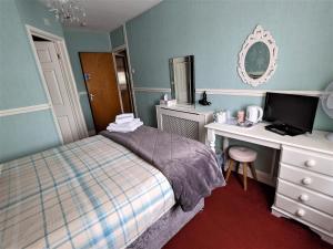 A bed or beds in a room at The Norman Guest House 