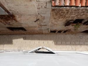 an empty room with a concrete ceiling and a wall at San Eleuterio Guesthouse in Poreč