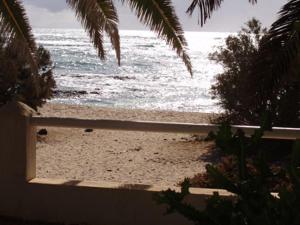 a view of a beach with the ocean at Maravilla Bungalows in El Cotillo