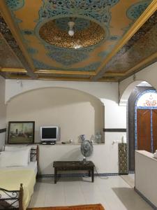 een woonkamer met een bank en een plafond bij Flashback House in Marrakesh