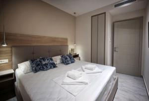 a bedroom with a large white bed with blue pillows at Villa Amoretta - Pisak (Omiš) in Pisak
