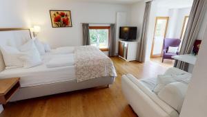 A bed or beds in a room at Hotel & Restaurant Dankl