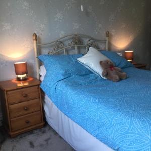 a teddy bear sitting on top of a bed at Endearing Edwardian House in Quaint Deal, Kent in Deal