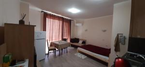 a small apartment with a kitchen and a living room at На море в Сарафово in Burgas City