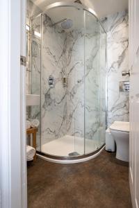 a bathroom with a shower with a toilet and a sink at Norwood House in Ambleside