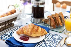 a table topped with a plate of croissants and jam at Norwood House in Ambleside +46 photos