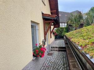 una casa con flores a un lado. en Ferienwohnung Mühlberg, en Seifersdorf