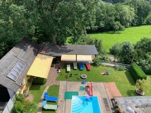 an aerial view of a backyard with a playground and a pool at Pino24 Ferienwohnungen mit Pool und Sauna in Hallenberg