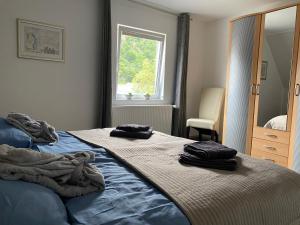 a bedroom with a bed with two towels on it at Ferienhaus am Baybach in Burgen an der Mosel in Burgen