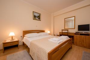 Postel nebo postele na pokoji v ubytování Villa Anggela