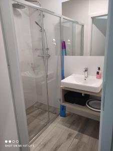 a bathroom with a shower and a sink at Apartament Tęcza in Rewal