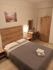 a bedroom with a bed with two towels on it at Summer Desire in Kavos
