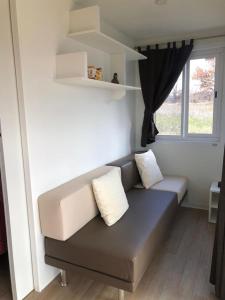 a couch in a living room with a window at In Country Luxury Lodges in Camerino