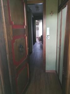 a hallway of a house with a door and a hallway at Condominio Royal ristrutturato in Sestriere