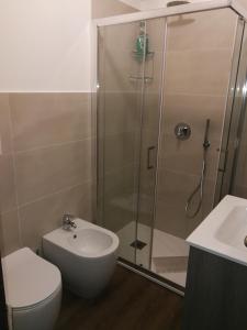 a bathroom with a shower and a toilet and a sink at Condominio Royal ristrutturato in Sestriere