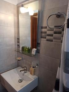a bathroom with a sink and a mirror at Summer Desire in Kavos +139 photos