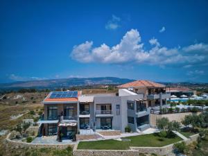 a house with solar panels on the roof at Tramonto Suites in Xi