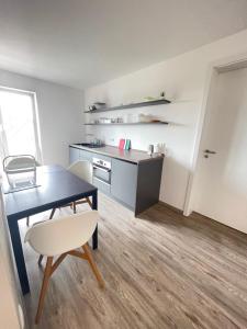 a kitchen and dining room with a table and chair at Gästehaus Hirsch 93 in Straubenhardt