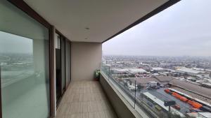 a balcony with a view of a city from a building at Frente del metro in Santiago
