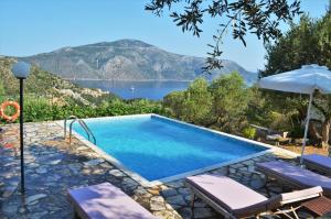 a swimming pool with a view of a lake at Ithaki House in Vathi