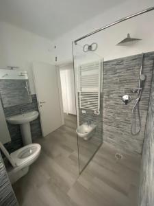 a bathroom with a shower and a toilet and a sink at VILLA IRMA in Varigotti