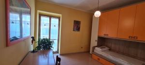 sala de estar con mesa, sofá y ventana en Casa La stella, en Pulcherini