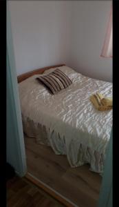 a bed with two pillows on it in a bedroom at Opremljen stan na Alipašin Polju in Sarajevo