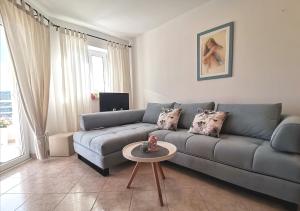 a living room with a couch and a table at Lovely apartment Branko Rabac with balcony and parking in Rabac