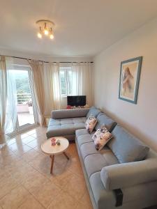 a living room with a couch and a table at Lovely apartment Branko Rabac with balcony and parking in Rabac