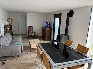 a living room with a stove in the middle at L'entre 2 Lyon Grenoble - Villa avec Jacuzzi in Izeaux