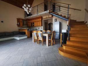 a kitchen and dining room with a table and chairs at Panorama Resort Balatonfüred in Balatonfüred