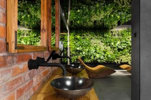 a metal sink in a brick wall with a window at Green Deer Premium in Zakopane