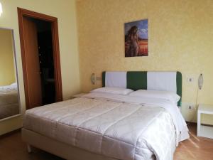 
A bed or beds in a room at Albergo Roma
