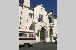 a white van parked in front of a white house at Entire Maisonette Torquay Newly Renovated in Torquay