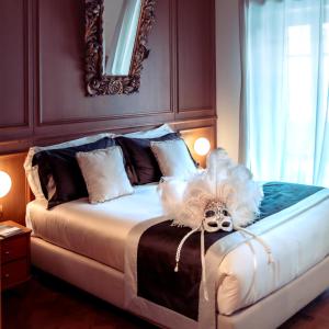 a bedroom with a bed with a mask on it at Ambra Cortina Luxury&Fashion Hotel in Cortina dʼAmpezzo