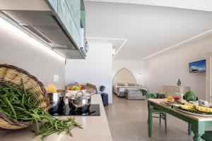 a kitchen with a table with fruits and vegetables on it at Livantea Agriresort e Residence in Otranto