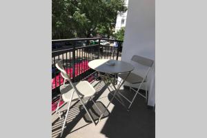 a patio with a table and chairs on a balcony at AIRCON & TERRACE IN TRIANA in Seville