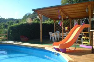 a swimming pool with a slide next to a house at Casa Elisa in Bibbiena
