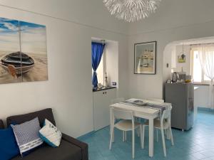 a living room with a table and a couch at La Casa di Paola in Nerano