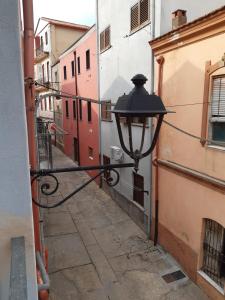 an alley with a street light on the side of a building at da paola in Iglesias