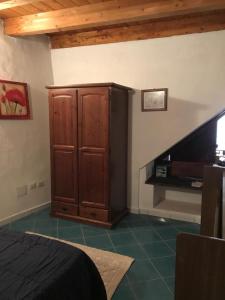 a bedroom with a large wooden cabinet in a room at da paola in Iglesias