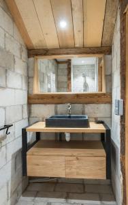 a bathroom with a sink and a mirror at La mine de Buck in Le Biot
