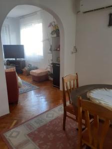 a living room with a table and a chair at Guest house Obzor in Obzor