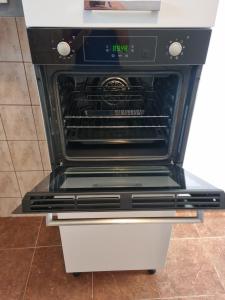 an oven with an open door in a kitchen at Apartment Ivana in Biograd na Moru